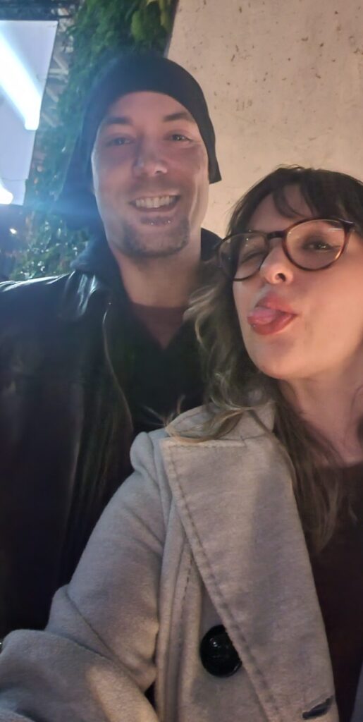 Two friends pose for a selfie outside a boutique marketing agency.