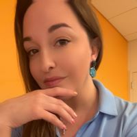 An attractive woman poses for a selfie in her office for a content marketing testimonial.