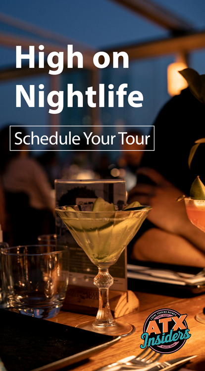 A martini sits on the bar of an open air rooftop patio at night. A display ad for Atx Insiders reading "High on Nightlife".