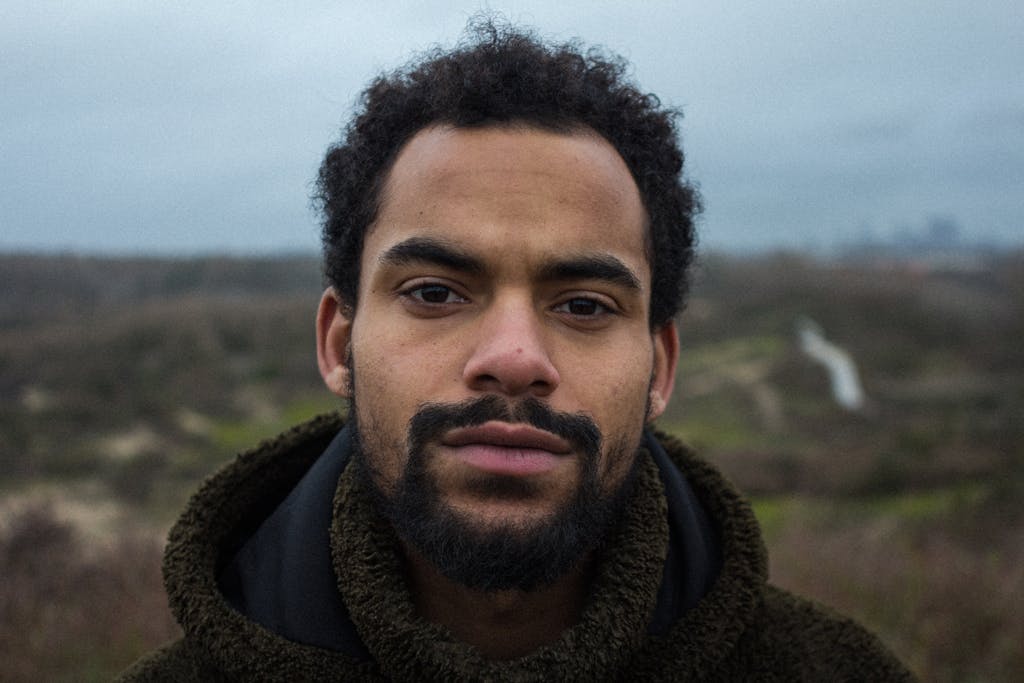 Portrait of a bearded man, outdoors in a winter landscape, and central figure for a marketing strategy persona.